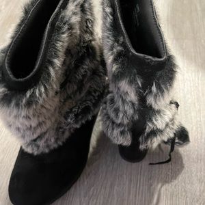 Egritte style winter wedge boots with laces around boots and pom poms.